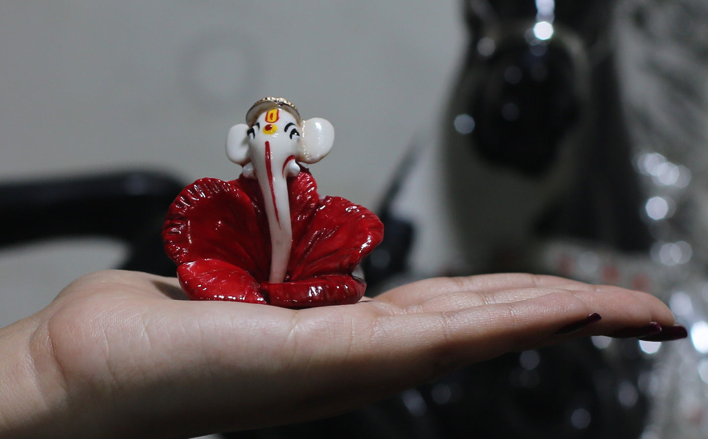 GANESHA WITH RED FLOWER